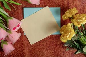 Floral arrangement with blank card on decorative background photo
