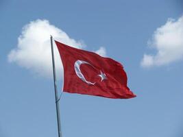 Turkish flag on a blue sky photo