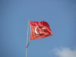 A red and white turkey flag flying in the wind photo