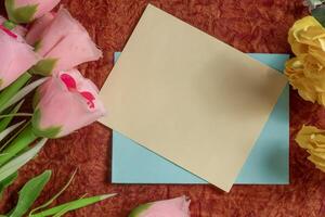 A blank card with flowers on a colorful background for greetings. photo