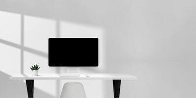 Bright office desk with computer monitor, keyboard, mouse, and plant, clean workspace with empty space on the right for copy or branding photo