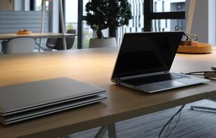 Laptops on a table being prepared and set up for new employees in a company photo