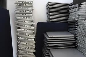 Many stacks of laptops in the storage room of a company photo