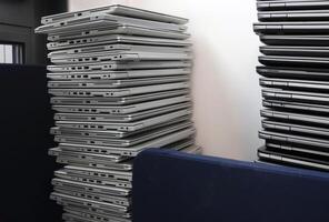 E-waste - pile of laptops in a storage room photo