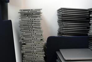 E-waste - big stacks of laptops to be discarded photo