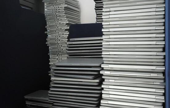 Electronic waste - multiple stacks of laptops in the storage room of a company photo