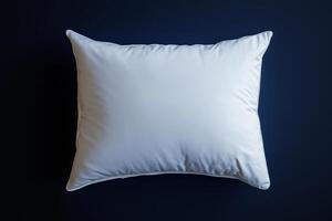 Soft white pillow resting on a dark blue background for stylish decor photo