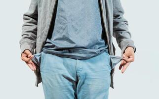 Closeup of person with empty pockets isolated. Concept of poverty and economic crisis photo