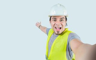 Selfie of smiling engineer inviting you isolated. Self portrait of happy construction engineer welcoming you photo