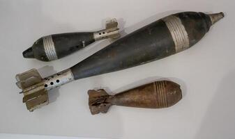 Old military shells and bombs. Severe attillery. A set of weapons. Weapon cartridges. Bomb, projectile, missile from the Second World War, museum piece photo