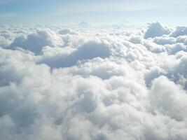 Clouds view from the airplane window. The sky is with cumulus clouds. Beautiful background. Travels. Flying over the cloud. To fly photo