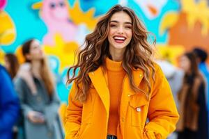 A woman in a bright yellow jacket smiles at the camera photo