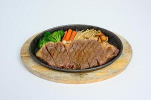 Wagyu beef slices set with vegetables on wooden tray photo