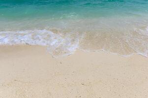 Waves splashing on white beach photo