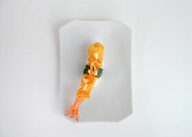 Deep fried shrimp tempura sushi nigiri with breadcrumbs and seaweeds photo
