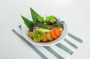 Head salmon kabutoni with soy sauce and vegetable photo