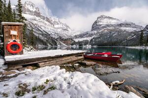 Scenery of Lake Ohara with red canoe in wooden dock on winter at Yoho national park photo