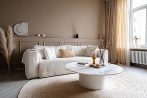 A living room with a white couch and a round table photo