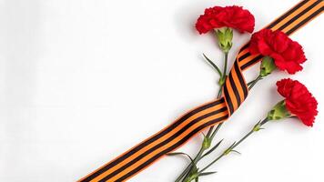 Red carnations and black-orange ribbon arranged in a meaningful display photo