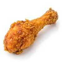 Crispy fried chicken drumstick resting on a clean white surface photo