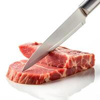 Fresh cuts of meat being sliced with a sharp stainless steel knife photo