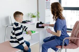 Boy testing breathing function by spirometry in doc office. Diagnosis of respiratory function in pulmonary disease. photo