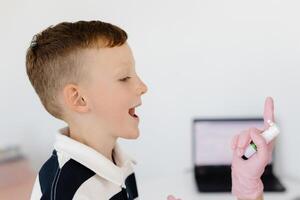 An allergist uses a spray for a patient to treat allergies. Allergen-specific immunotherapy. photo