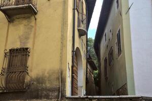 Alley between tall buildings seen from below photo