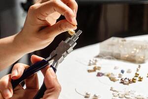 A Hands of a person using round nose multipurpose pliers. photo