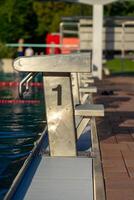 View of the starting blocks in the outdoor pool on a summer evening photo