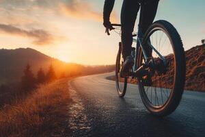 Biker enjoying a breathtaking sunset ride on a winding road in a scenic landscape photo
