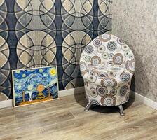 Artistic corner featuring a unique chair and a whimsical painting in a cozy room with creative design elements photo