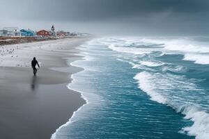 Surfer walks along a deserted beach under cloudy skies in a coastal town photo