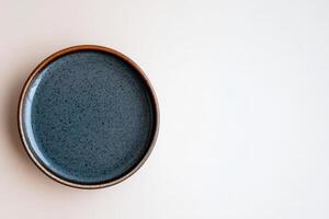 Decorative blue plate on a clean surface with simple design and natural tones photo