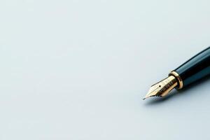 Elegant fountain pen poised on pristine white surface during a creative writing session photo