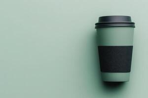 Stylish reusable cup on a green background for eco-conscious drinkers and coffee lovers photo