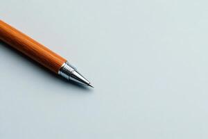 Wooden pen rests atop a smooth surface ready for writing or drawing photo