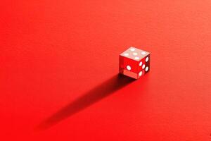 Red dice on a vibrant surface creating striking shadow patterns photo