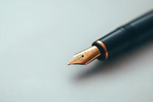 Elegant fountain pen rests on a smooth white surface ready for writing in a quiet workspace photo