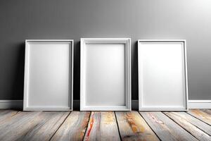 Blank frames arranged on a wooden floor against a gray wall ready for artwork or photos