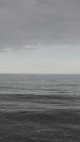 Flying over ocean with grey water. Footage. aerial view flying over water with dramatic clouds video