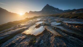 Mountain landscape at sunset with glowing light layered rocky terrain and dramatic peaks photo