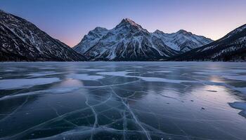 Frozen lake with visible ice cracks snow-covered mountains and clear sky creating breathtaking winter scenery photo