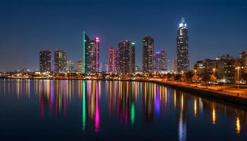 Illuminated buildings with reflections on calm water surrounded by trees and streetlights in vibrant cityscape photo