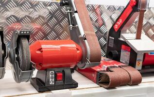 red corded jigsaw cordless drill and speed variable power small plunge router milling machine portable mini wood router on vintage wooden background photo