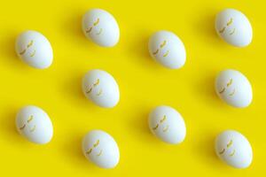Easter eggs pattern on colorful yellow background. Top view, flatlay. photo