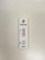 Test positive using a COVID-19 rapid testing device photo