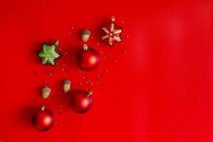 Christmas composition, red, gold and green decorations on a red background photo