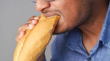 Man enjoys fresh bread during casual meal at home video