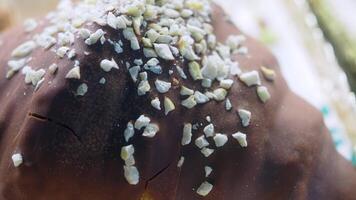 Delicious chocolate dessert topped with crushed nuts on display video